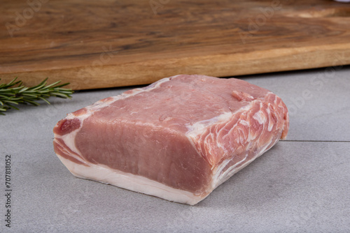 raw pork pig meat loin on grey background with wooden board