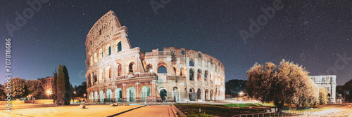 Rome, Italy. Colosseum Also Known As Flavian Amphitheatre In Evening Or Night Time. Bold Bright Blue Night Starry Sky With Glowing Stars Above Colosseum. Panoramic View. Travel To Italy. © Grigory Bruev