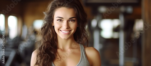 Sporty beautiful woman fitness trainer smiling in the gym. with sunshine.
