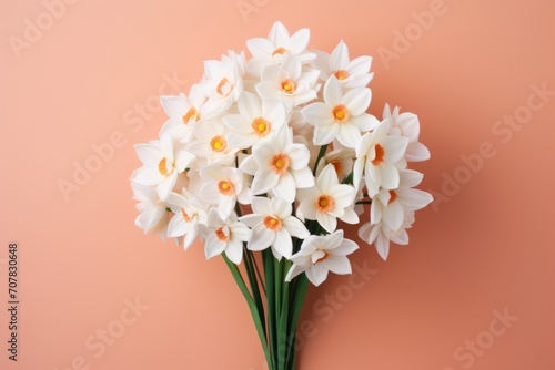 Bouquet of white narcissus on a coral colored backdrop isolated pastel background  © Lenhard