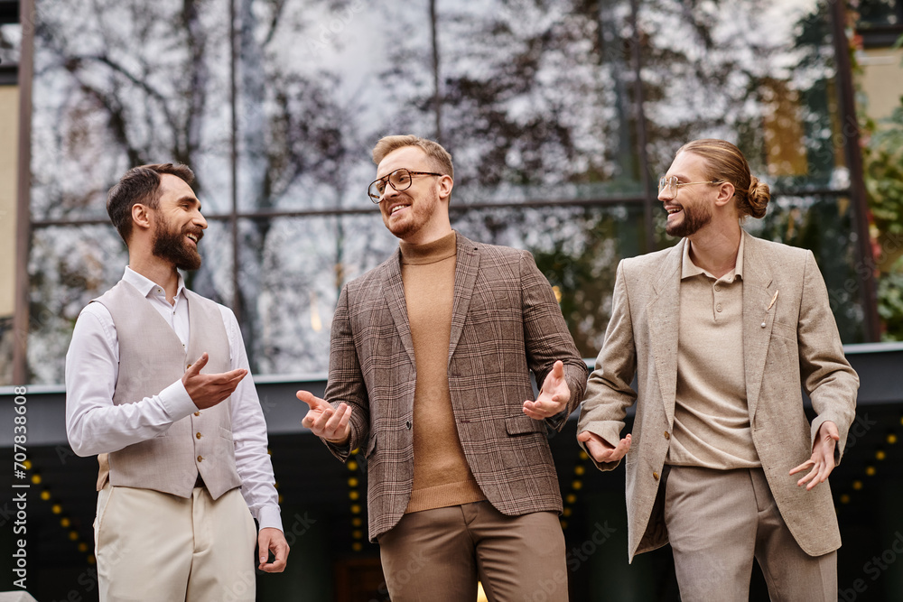 cheerful handsome business leaders with glasses in fashionable attires discussing their startup cheerful handsome business leaders with glasses in fashionable attires discussing their startup