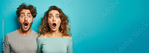 Banner Surprised couple. Omg, check this. Emotional guy and girl free space over grau background, surprised lady looking at camera, panorama. Couple demonstrating place for your text photo