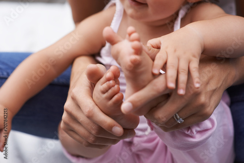 Baby, feet and mom hands with love, bonding and child care with parenting and youth outdoor. Family, support and young kid with newborn, holding and barefoot with trust, toddler and relax with mother