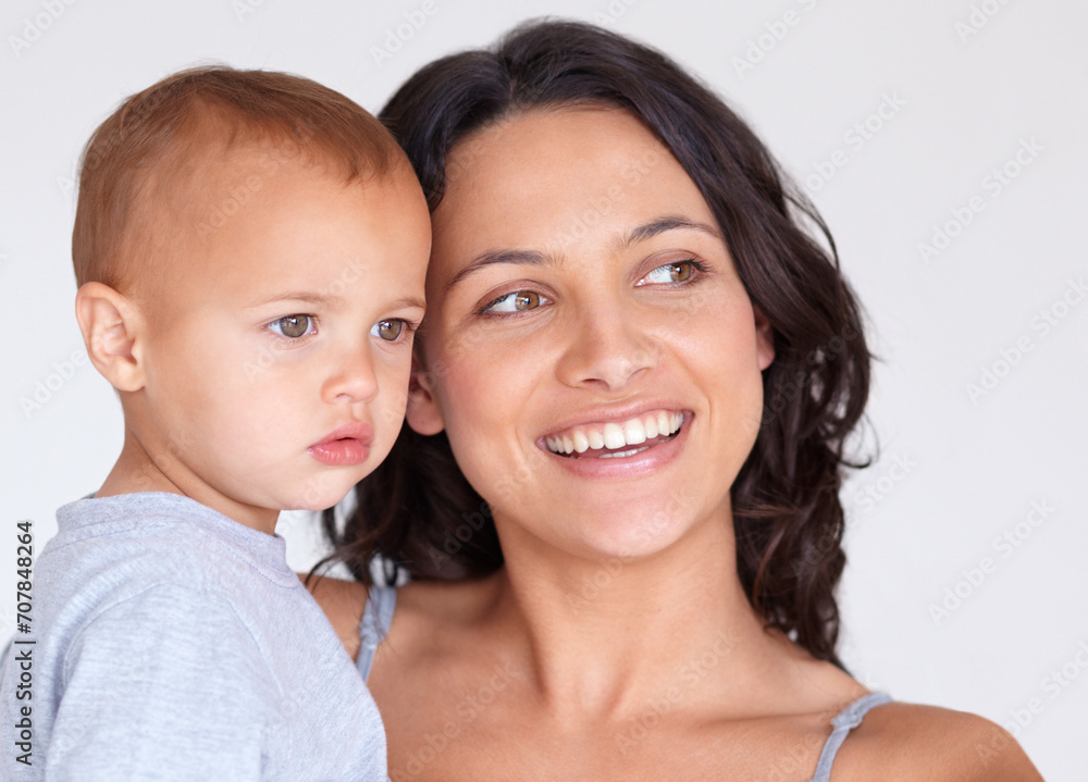 Happy, smile and mother with baby on a white background for bonding, relationship and relax together. Family, youth and face of mom carrying kid for growth, playing and child development in studio Happy, smile and mother with baby on a white background for bonding, relationship and relax together. Family, youth and face of mom carrying kid for growth, playing and child development in studio