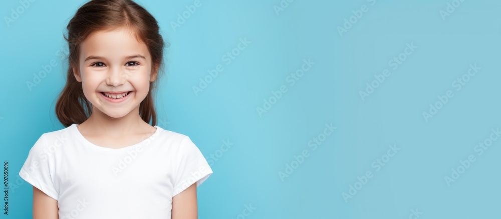 Vaccinated child girl in white T-shirt on blue background, studio setting, space for text, about vaccination, health, and medicine. Vaccinated child girl in white T-shirt on blue background, studio setting, space for text, about vaccination, health, and medicine.