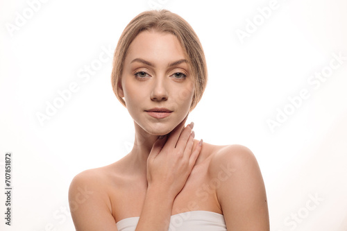 Beauty portrait of a beautiful girl on an isolated white background. Skin care concept. Cosmetology