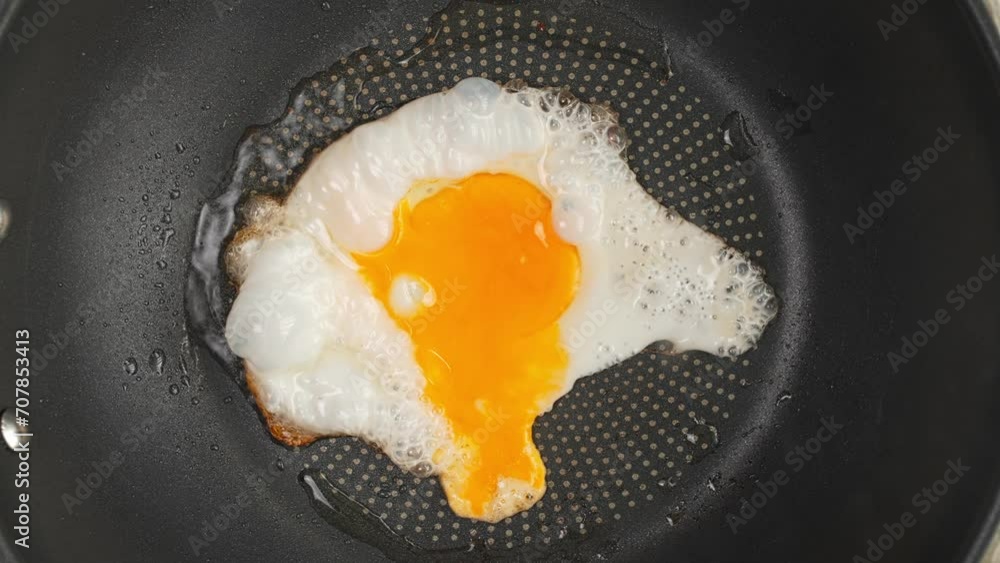 One egg fried in a frying pan top view. High quality 4k footage, Timelapse video of cooking a fried egg in a frying pan top view One egg fried in a frying pan top view. High quality 4k footage, Timelapse video of cooking a fried egg in a frying pan top view