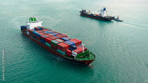 logistic cargo container ship sailing in sea to import export goods and distributing products to dealer and consumers across worldwide, aerial side view