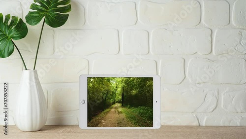 path shown on tablet screen standing next to vase .4k video resolution