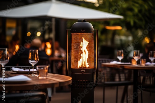 restaurant terrace with outdoor heaters with fire flame closeup. Gas heating equipment. Romantic date. Europe in winter, gas prices inflation.