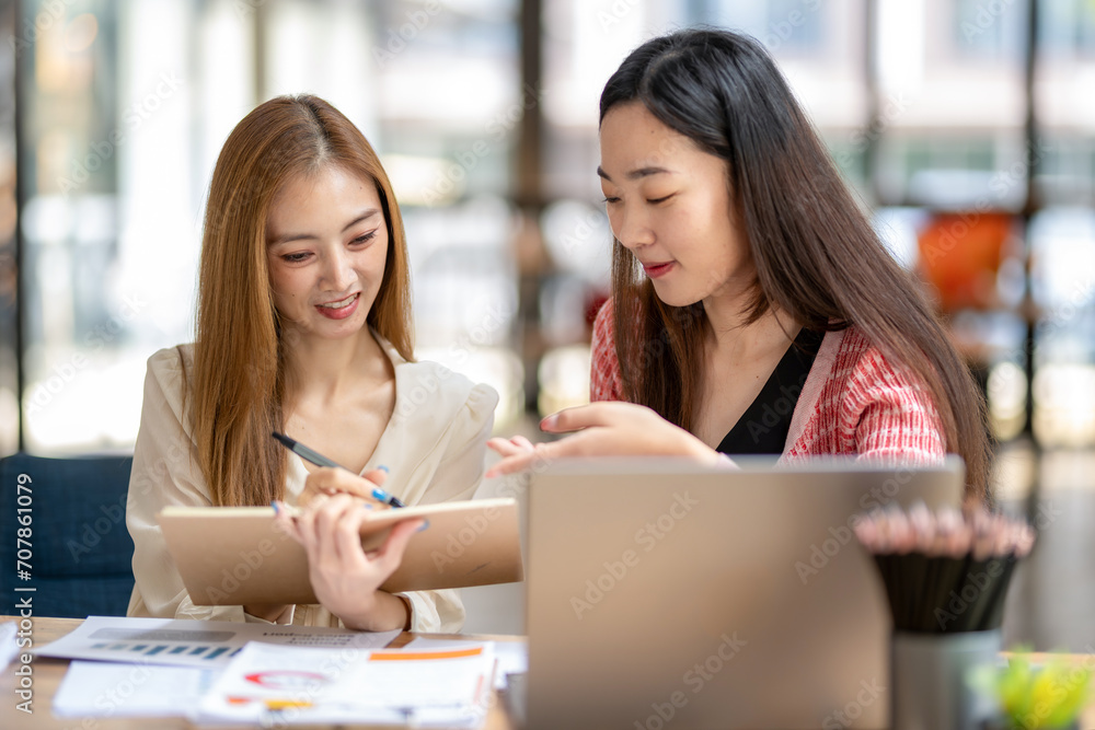 Two business colleagues discuss and share ideas about a new project. Two business colleagues discuss and share ideas about a new project.