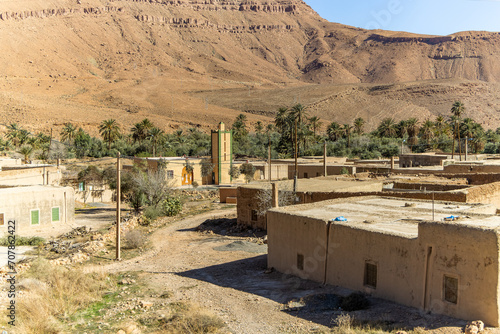 Aoufous, Morocco. Traditional muddy houses by palm oasis around river Ziz. photo