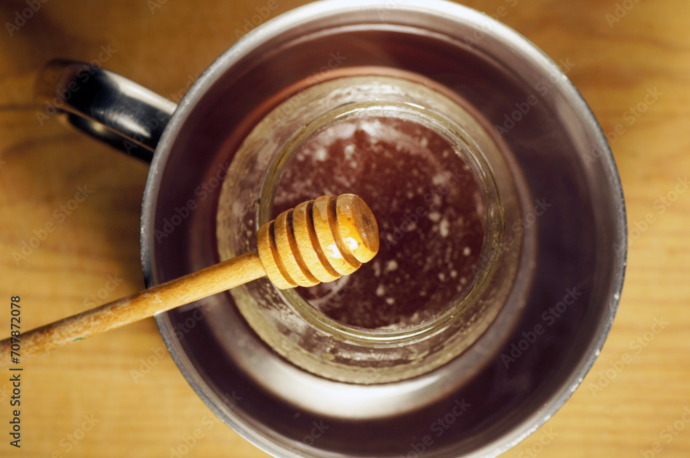 honey dipper close up with the organic product on background unfocused honey dipper close up with the organic product on background unfocused