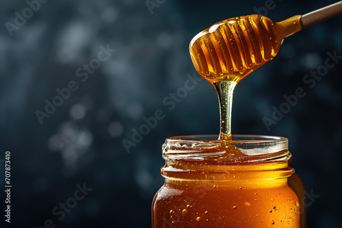 Close-Up of Golden Honey Dripping from Dipper into Glass Jar