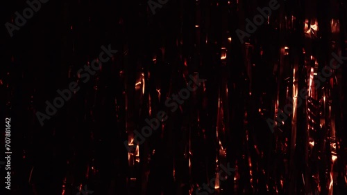 Festive red tinsel. Red shower as background and texture. Party Background. Decor foil and tinsel. Festive photo