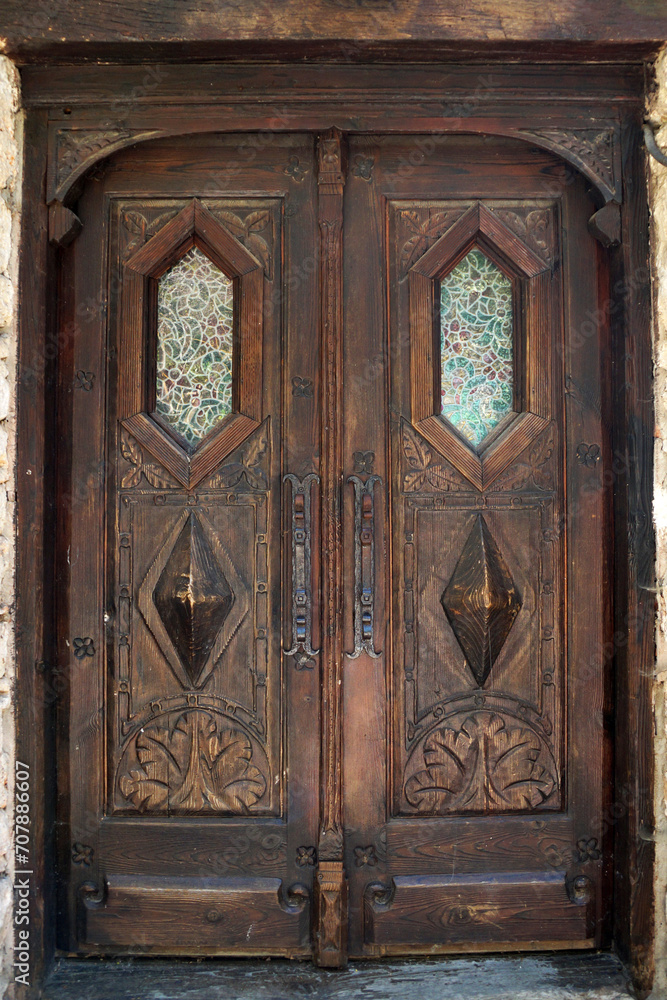 antique, double-leaf, brown entrance door with decor and glass antique, double-leaf, brown entrance door with decor and glass