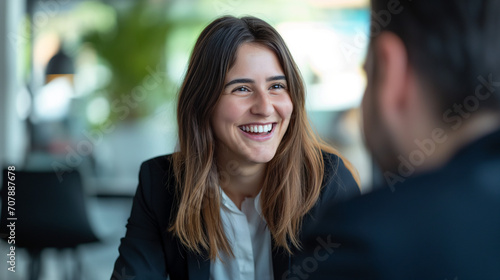 Young Woman in Business Dress at Job Interview, Smiling in Professional Office Setting, Positive Interaction with HR, Successful Meeting and Agreement in Formal Meeting Room