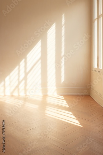 Light beige wall and wooden parquet floor  sunrays and shadows from window