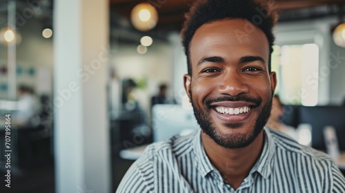 A captivating image featuring a businessman beaming with a sincere smile, the high-resolution camera capturing the authenticity and positivity that resonates throughout the office environment
