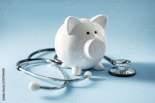 Piggy bank with stethoscope, medical insurance or money health check concept