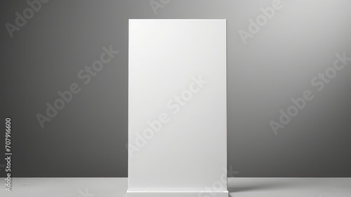 Blank roll up banner stand in grey room.