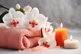 Spa items: soap, candle, towel, salt, orchid on white. Salon, therapy, beauty. Treatment. Coral.