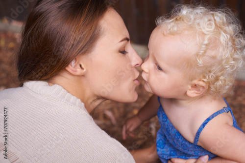 Mother, love and kiss of baby in house, trust and parent support for mama bond with happiness in care. Woman, nurture and toddler daughter with together, wellness and hug kid for bonding in apartment