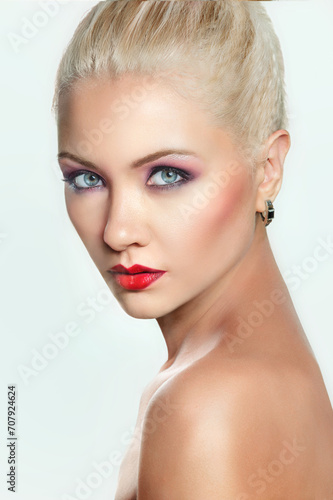 Portrait of attractive blonde woman with bright make-up and red lipstick