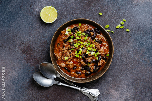 Beef chili con carne with green onions directly above
