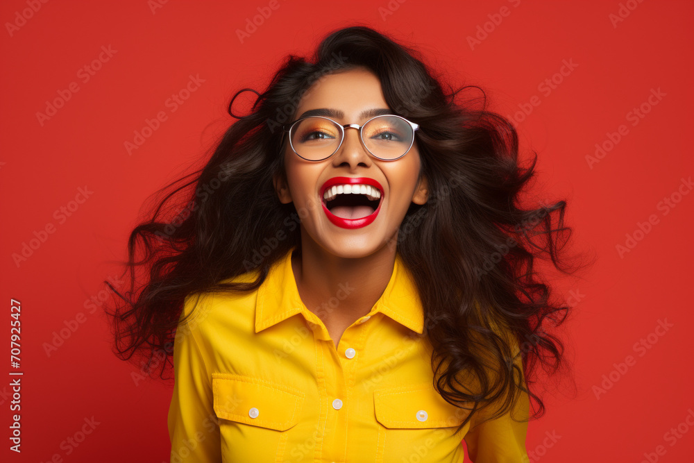 a happy and excited young girl laughing on red background a happy and excited young girl laughing on red background