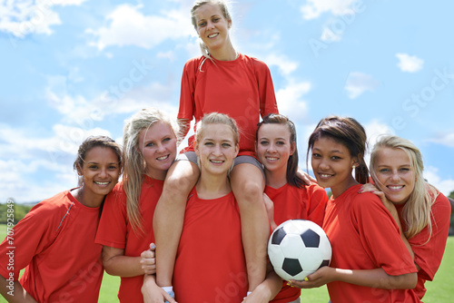 Women, soccer players and portrait with ball, confidence and football field for match, competition or game. Fitness, practice and happy for training, outdoor and exercise for athlete, girls or sport