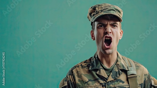 Soldier shouts angrily looking at camera. photo