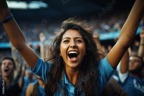 indian women cricket fan wearing blue jersey cheering photo