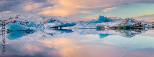 Panorama of Iceberg reflections in Jokulsarlon glacier lagoon in Iceland photo