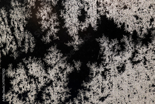 The texture of frost on frozen glass. Glass in winter