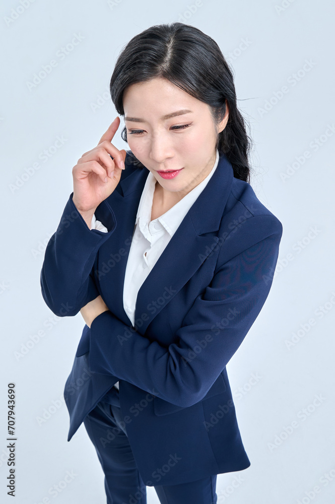 A young businesswoman in a suit is making various facial expressions and gestures. A young businesswoman in a suit is making various facial expressions and gestures.