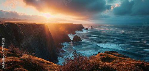 A panoramic view of a rugged coastline with cliffs and a dramatic sunset over the ocean,