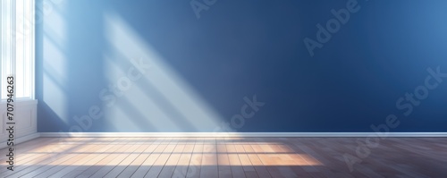 Light navy wall and wooden parquet floor, sunrays and shadows from window photo