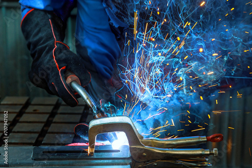 During welding process of argon gas on steel sparks are created that cause smoke to be generated in factory photo