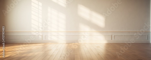 Light zaffre wall and wooden parquet floor, sunrays and shadows from window photo