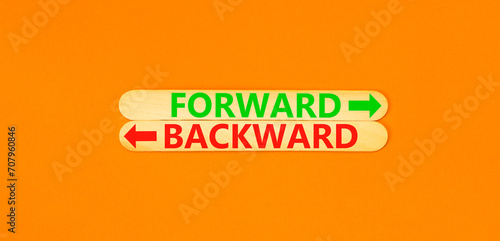 Forward or backward symbol. Concept word Forward or Backward on beautiful wooden stick. Beautiful orange table orange background. Business forward or backward concept. Copy space.