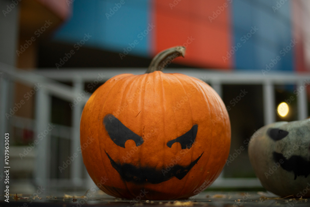Pumpkin with a terrible face. Black paint on pumpkin. Harvest Day. Pumpkin with a terrible face. Black paint on pumpkin. Harvest Day.