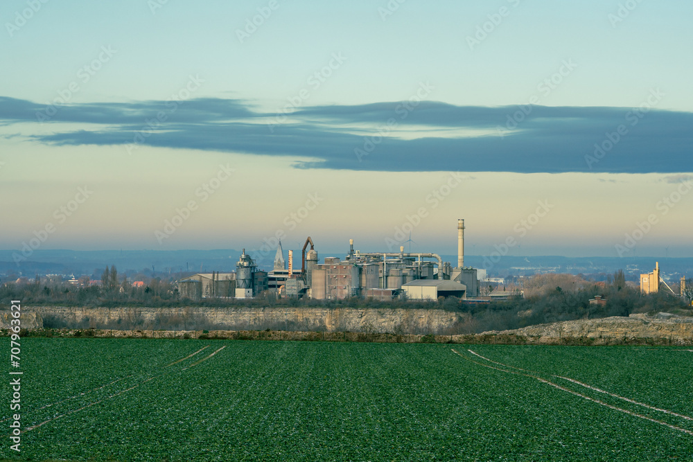 Fototapeta premium Concrete factory in a rural area in the sunset and copy space