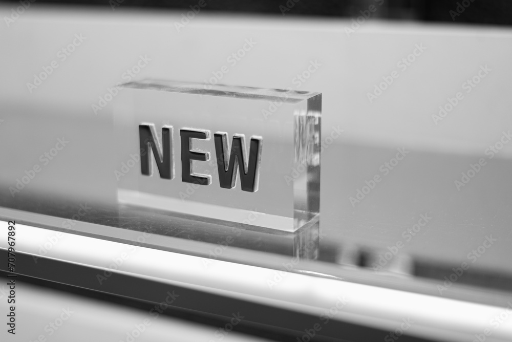 Transparent cube with a three-dimensional inscription New. Selective focus, black and white, concept.
Transparent cube with a three-dimensional inscription New. Selective focus, black and white, concept.