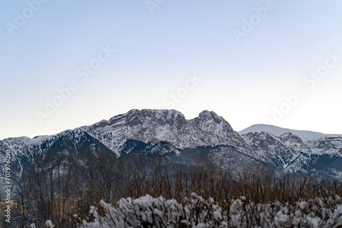 Giewont mountain massif  peak in the Tatra Mountains range  seen from Zakopane town  Poland. Part of Tatra National Park. Scenic landscape  iconic sleeping knight silhouette covered with winter snow.