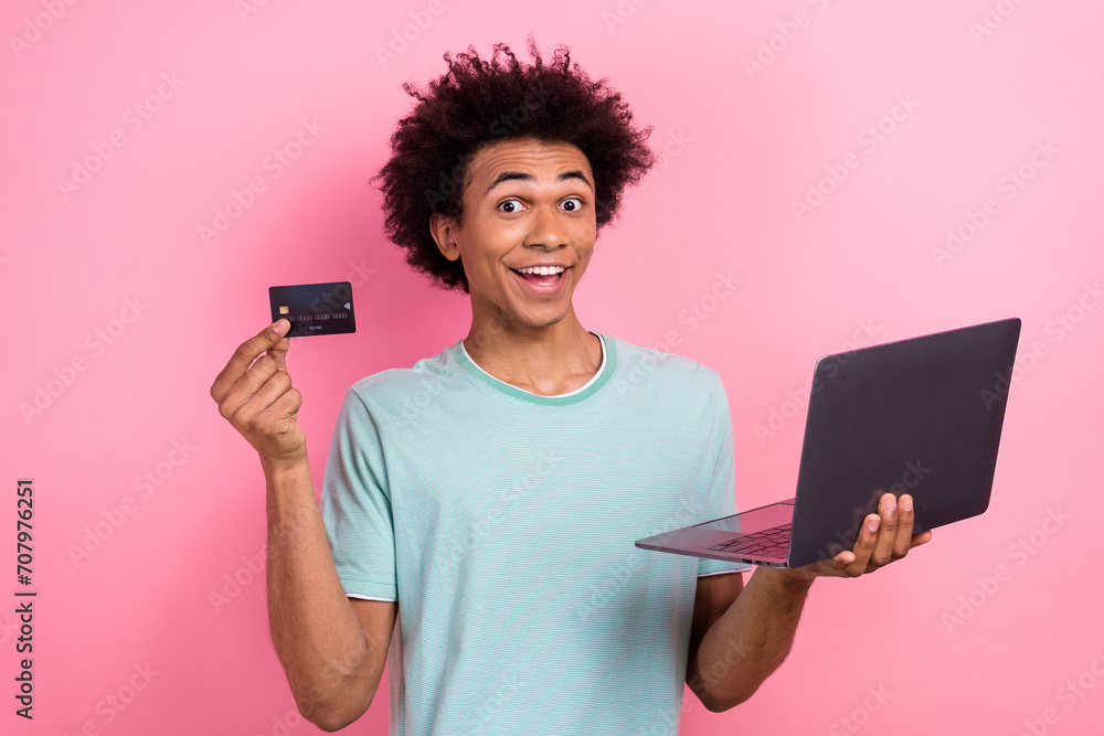 Photo of cool impressed man dressed blue t-shirt online shopping modern gadget isolated pink color background Photo of cool impressed man dressed blue t-shirt online shopping modern gadget isolated pink color background