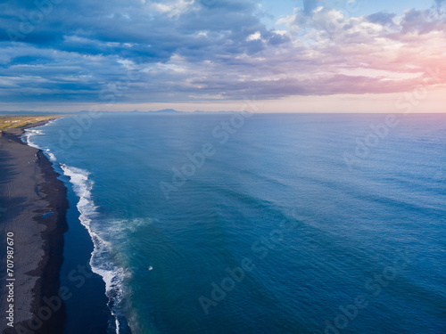 Sunset Landscape of Khalaktyrsky beach with black volcanic sand coast of North Pacific Ocean Kamchatka Russia, aerial top view © Parilov