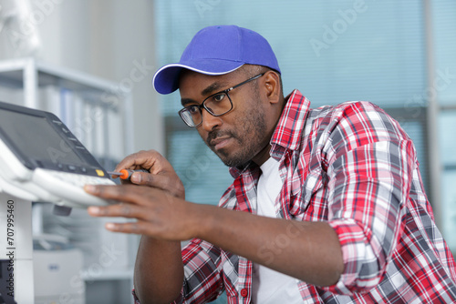 male technician repairing electric panel