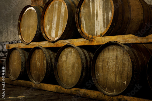 Rustic wooden barrels in the cellar. © 9parusnikov