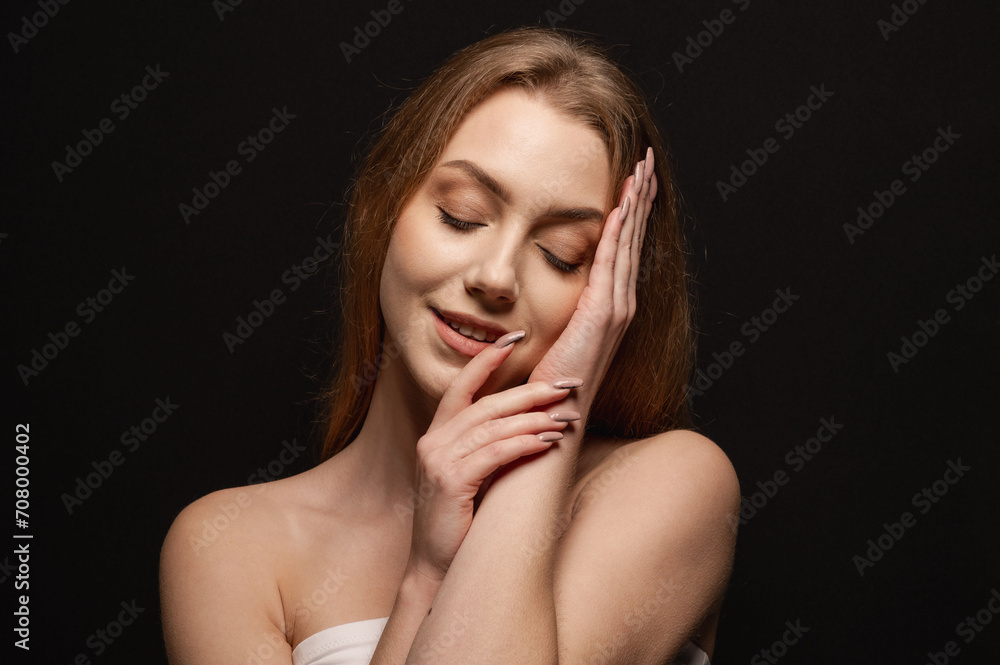 Beatiful portrait of a beautiful and gentle blonde girl on an isolated black background. Skin care Beatiful portrait of a beautiful and gentle blonde girl on an isolated black background. Skin care